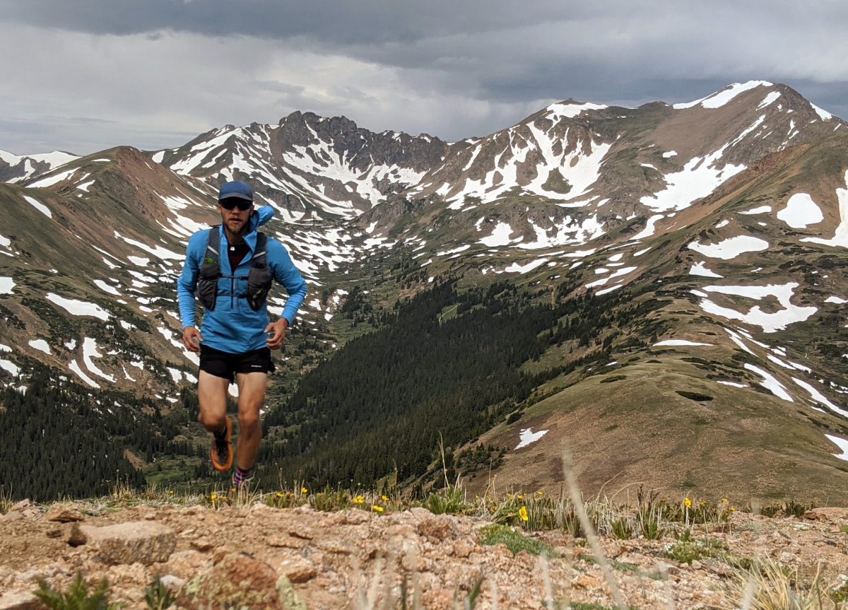 I always carry my Airshed Pro pullover in my vest on mountain runs. It takes up very little space in the vest pocket, but does wonders for staying warm on windy ridges. Unlike most windbreakers with a coated or impregnated fabric, this pullover is super breathable and I can keep wearing it even when running hard. Patagonia Running Kit 2024 - Drew Thayer of Engearment.com